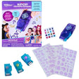 Cool Maker KPop Demon Hunters Shimmer Me Tattoo kit with purple retail packaging featuring Rumi, Mira and Zoey, a purple HUNTR/X foil roller, three turquoise foil cartridges, purple tattoo design sheets and colourful adhesive gems.