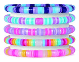 Five finished multicoloured Heishi bead bracelets stacked together 