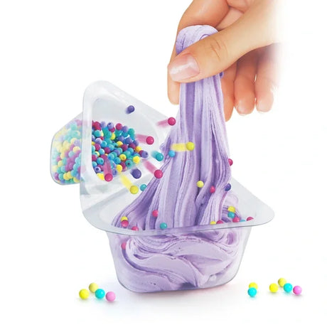 Hand stretching purple slime while rainbow beads pour from top compartment – Ireland