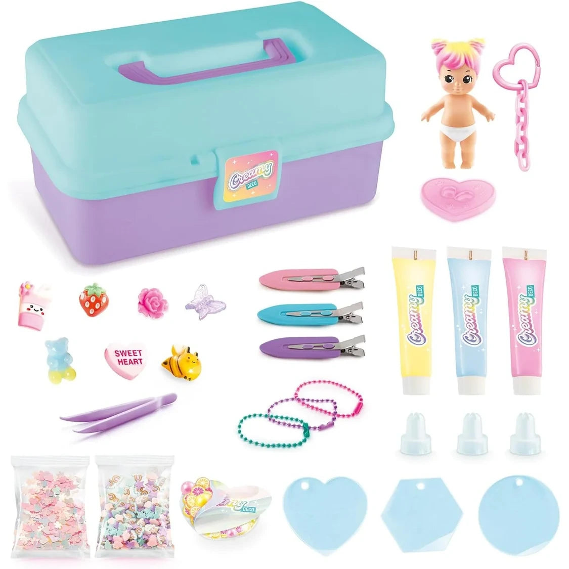 Creamy Deco Activity Case contents arranged on a white background, including the turquoise and purple case, baby doll, pink heart stand, three cream tubes, piping nozzles, tweezers, hair clips, charms, decorative pieces, keychain chains and three blue acrylic shapes.