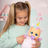 Young girl holding Cry Babies Luna in her pink unicorn outfit, with pink musical notes showing the doll's sound feature.