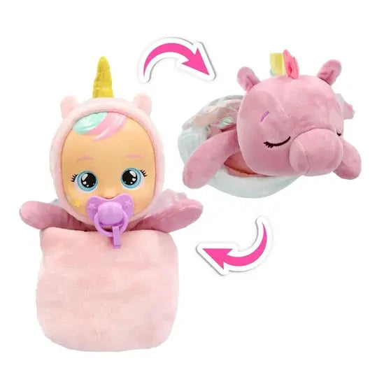 Cry Babies Luna baby doll with unicorn horn and purple dummy beside pink Poppy Pegasus with closed eyes, with curved arrows showing the reversible transformation.