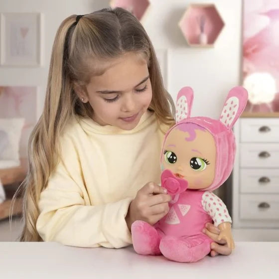 Child interacting with Cry Babies Meal Time Julie doll using her matching dummy accessory.