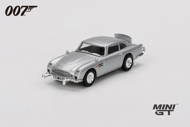 Mini GT James Bond Goldfinger Aston Martin DB5 silver RHD model viewed from the front left showing the chrome grille, front bumper details and wire style wheels