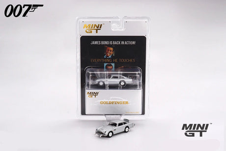 Mini GT Goldfinger Aston Martin DB5 displayed with its 007 blister packaging and a loose silver DB5 model positioned in front