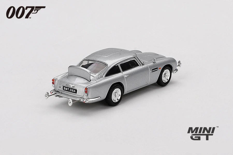 James Bond Goldfinger Aston Martin DB5 silver RHD model viewed from the rear showing the tail lights, chrome bumper, exhausts and rear body shape