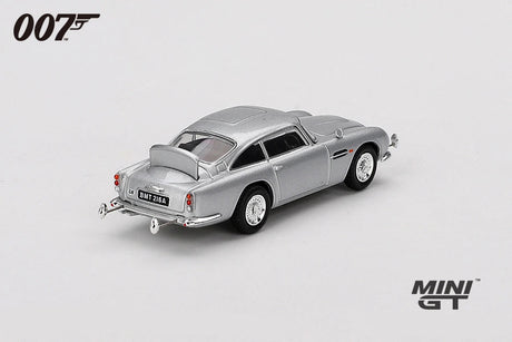James Bond Goldfinger Aston Martin DB5 silver RHD model viewed from the rear showing the tail lights, chrome bumper, exhausts and rear body shape
