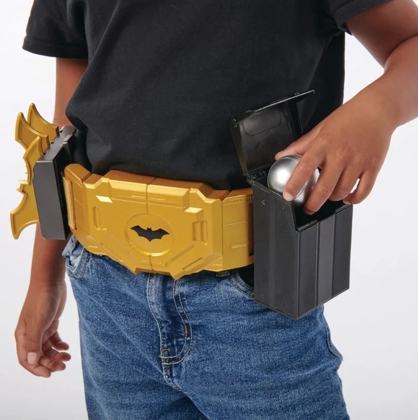 Child wearing DC Batman Utility Belt inserting silver gadget ball into black side compartment