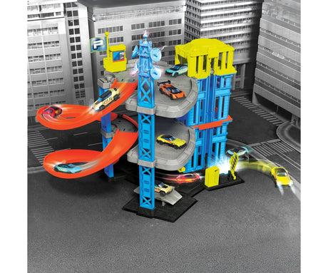 Dickie Parking Station Garage with orange spiral ramps, multiple colourful toy cars, yellow roof sections and a black and white city street background.