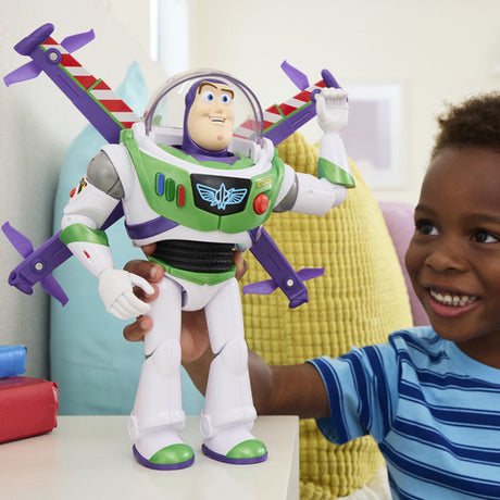 Disney and Pixar Toy Story 12 Inch Buzz Lightyear figure with its wings raised while a smiling child holds the figure upright.