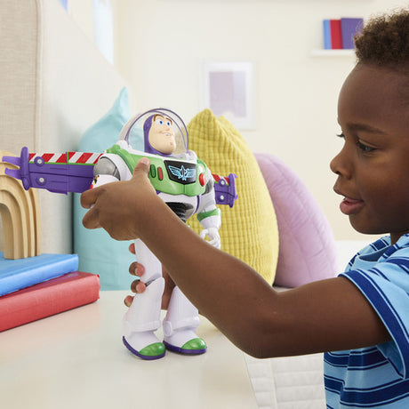 Disney and Pixar Toy Story 12 Inch Buzz Lightyear figure with its wings extended sideways while a child holds the figure with both hands. 