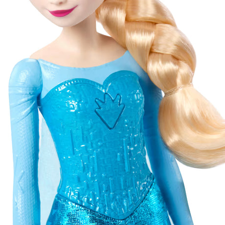 Close view of the Disney Frozen Light-Up Singing Elsa Doll with a blue bodice, hand symbol and blonde braid.