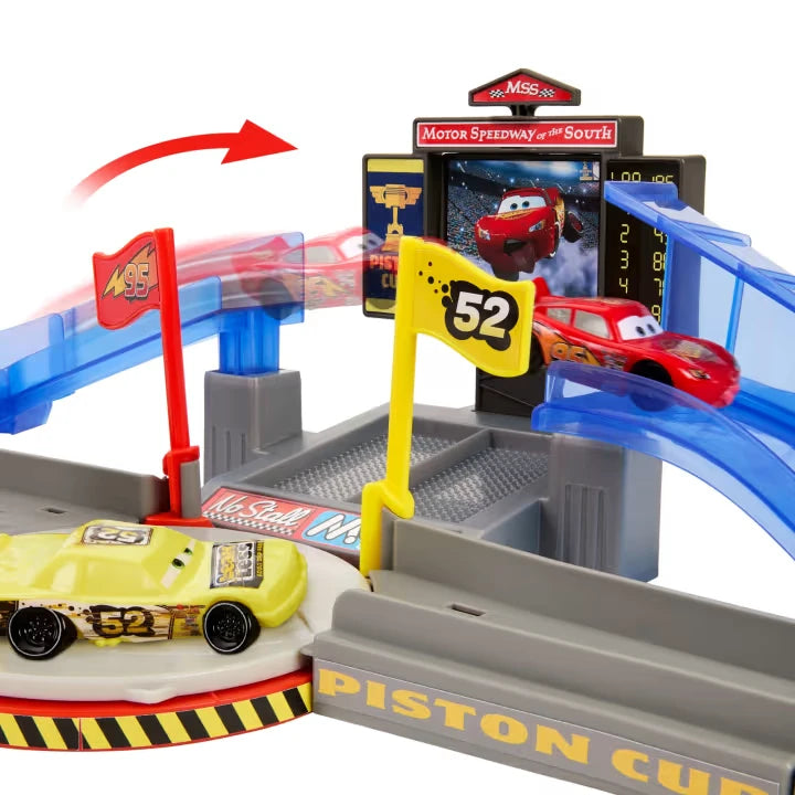 Disney Pixar Cars playset close up with red car on blue ramp beside yellow number sign