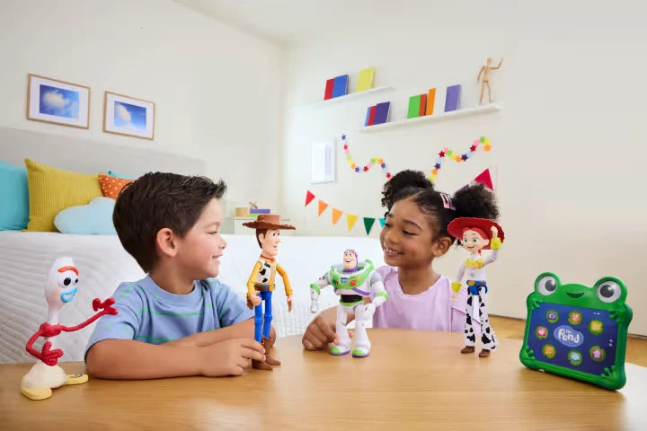 Children at a table with Toy Story figures and a green toy screen visible