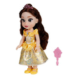 Disney Princess Belle doll shown from an angled view with pink brush beside her