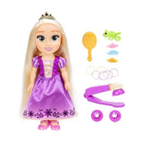 Rapunzel doll beside gold hairbrush, Pascal figure, hair clips, bands and purple styling tool