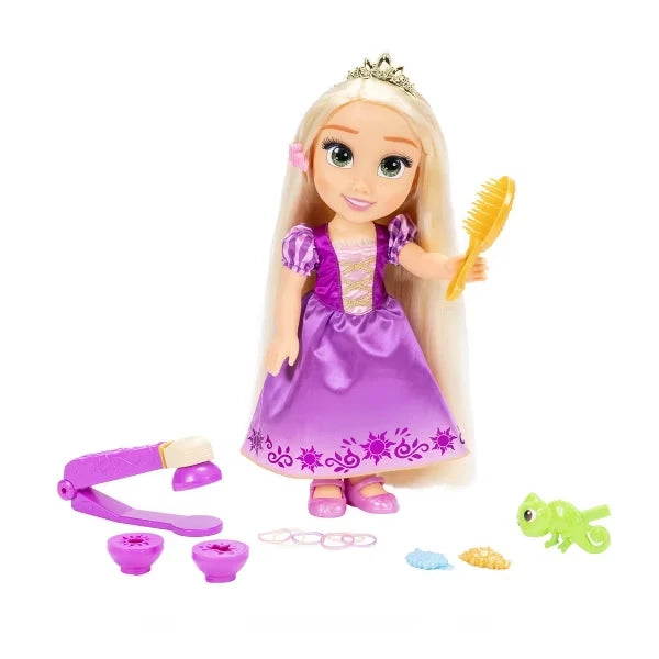 Rapunzel doll holding a gold hairbrush with purple styling tool, Pascal figure, hair clips and bands beside her