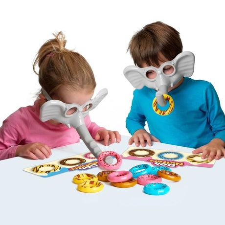 Two children wearing Doh Nutters elephant masks and picking up colourful doughnuts with the trunks