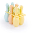 Pastel coloured bowling pins and balls grouped together on a white background