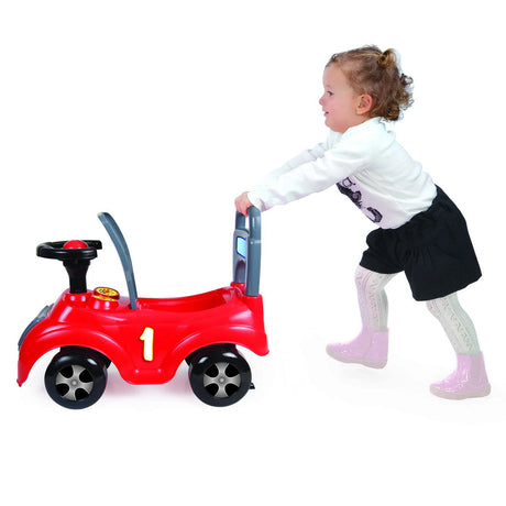 Child pushing a red Dolu sit n ride car on a white background