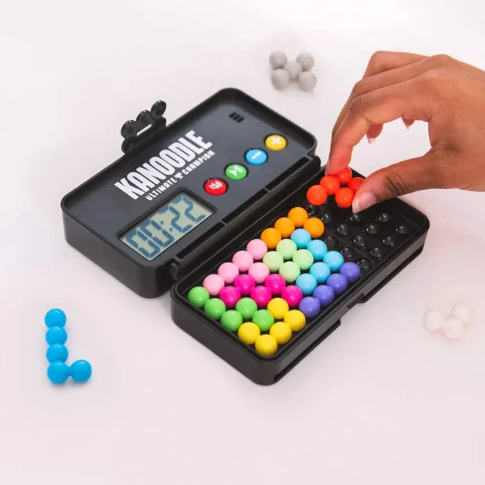 Hand placing pieces in Educational Insights Kanoodle Ultimate Champion puzzle game