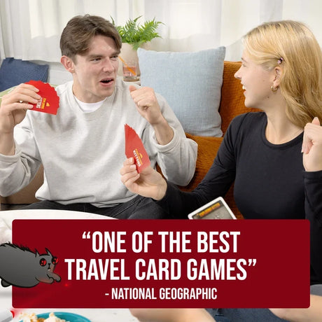 Two people sitting on a sofa holding red Exploding Kittens cards, with a National Geographic promotional quote across the bottom.
