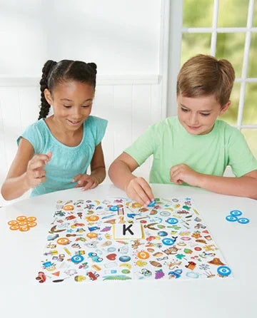 Children playing Eye Spy With My Little Eye board game with tokens and picture board in Ireland