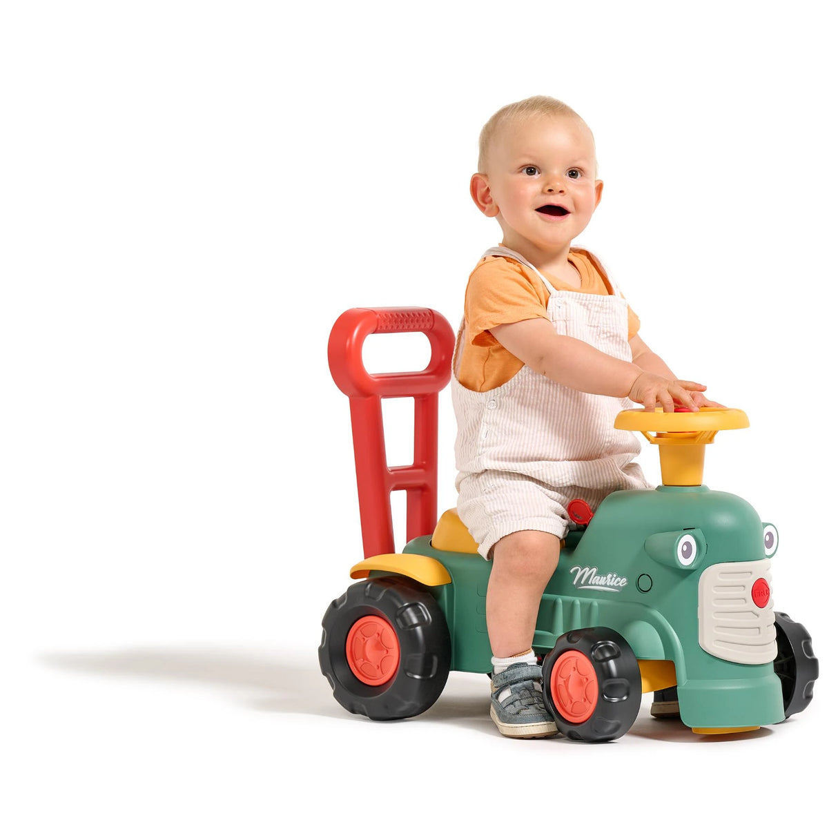 Child sitting on Falk Maurice Vintage Baby Green Tractor