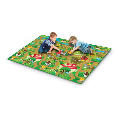 Farm Playmat 200 × 120 cm laid on the floor with two children playing on the farm and road design