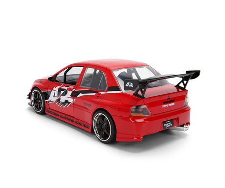 Red Mitsubishi Lancer EVO IX diecast car viewed from the rear and side, showing the large black spoiler, racing graphics, Toyo Tires branding and black wheels.