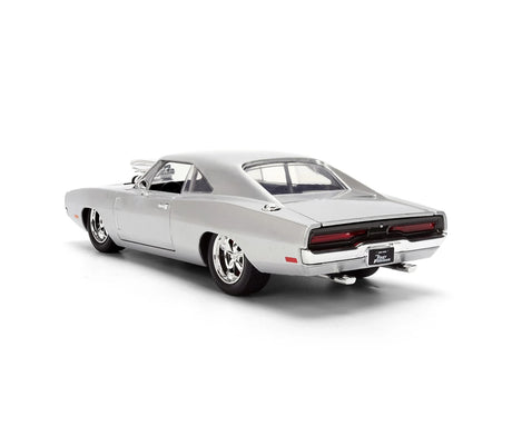 Silver 1970 Dodge Charger viewed from the rear and side, showing the full-width rear lights, chrome bumper, twin exhaust pipes and Fast & Furious number plate.