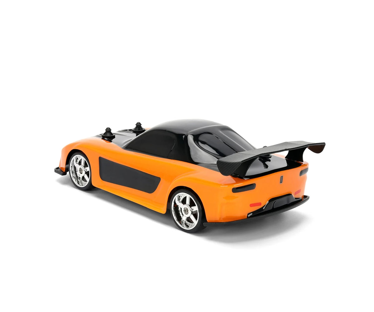 Orange Fast & Furious Mazda RX-7 remote control car viewed from the rear and side, showing black roof, large rear wing, silver wheels and black side panels.