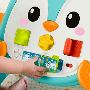 Close-up of the Fisher-Price Musical Penguin Walker activity panel with shapes, rollerball and musical flipbook