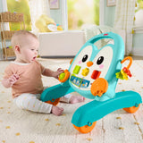 Baby seated beside the Fisher-Price Musical Penguin Activity Walker reaching for the activity controls