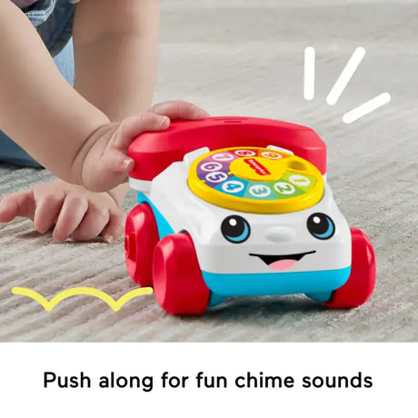 Hand pushing the Fisher-Price Chatter Telephone Vehicle to hear chime sounds
