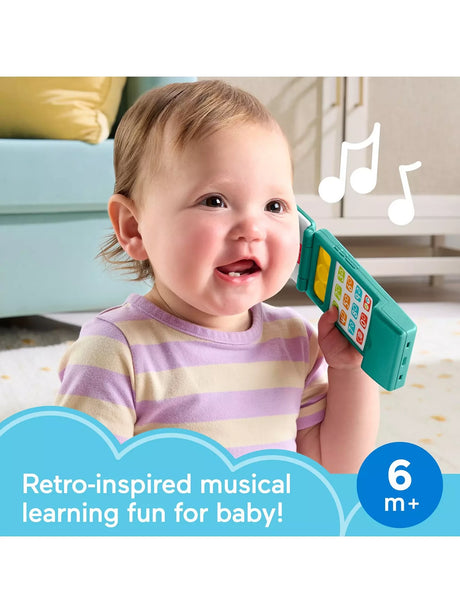 Baby holding the Fisher-Price Laugh & Learn Flip Phone toy to their ear
