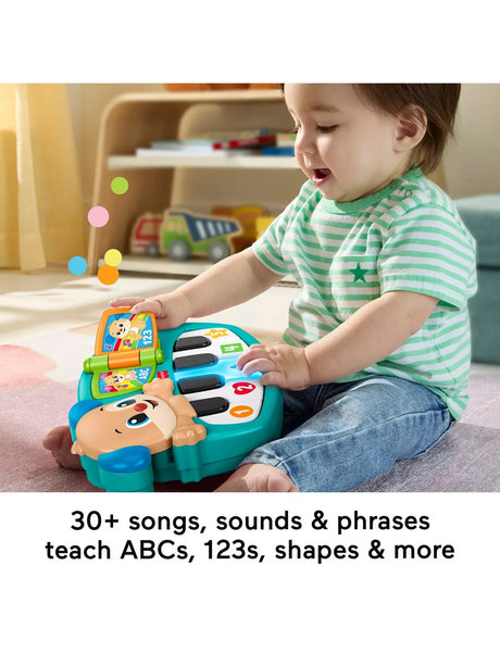 Toddler playing with the Fisher-Price Laugh & Learn Puppy's Piano Musical toy