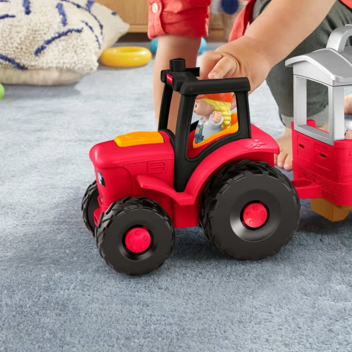 Fisher-Price Little People Caring for Animals Tractor close view with farmer figure in driver seat and child pressing tractor