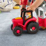 Fisher-Price Little People Caring for Animals Tractor close view with farmer figure in driver seat and child pressing tractor
