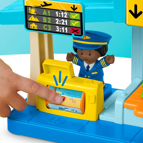 Close-up of Fisher-Price Little People airport playset with figure beside the luggage conveyor