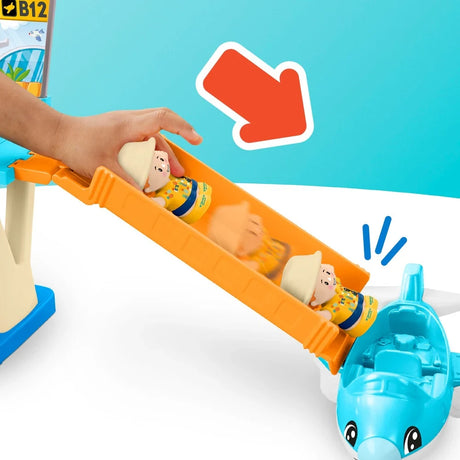 Fisher-Price Little People figure sliding down the orange slide towards the blue toy plane