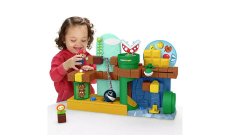 Child playing with Fisher-Price Little People My Mario Adventure Playset and Mario figure