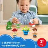 Child playing with Fisher-Price Little People Toy Story figures including Rex, Buzz Lightyear, Jessie, Alien, Woody and Forky