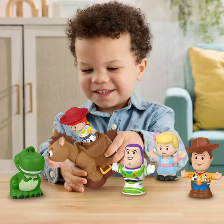 Child playing with Jessie and Bullseye alongside other Little People Toy Story figures