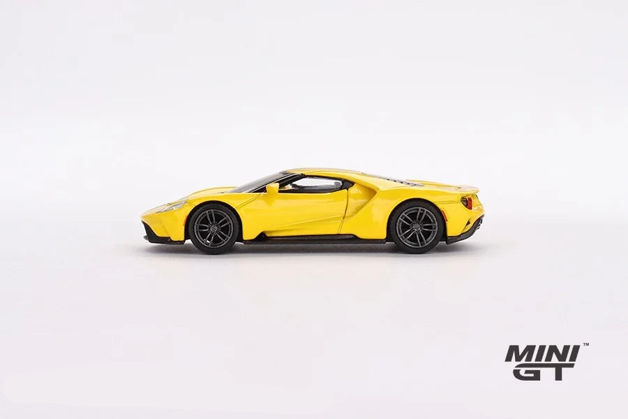 Mini GT Ford GT Triple Yellow LHD model in full left side profile showing the low body, large side intake, dark wheels and black lower trim
