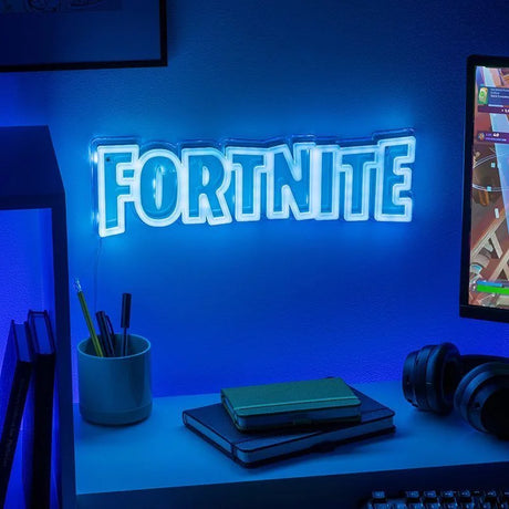 Fortnite LED Neon Wall Light glowing blue on wall above gaming desk in Ireland.