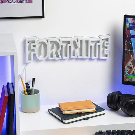 Fortnite LED Neon Wall Light turned off on wall beside gaming setup in Ireland.