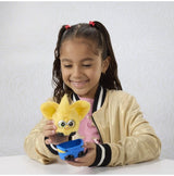 Child playing with Furby Furblets Minions plush toy at a table