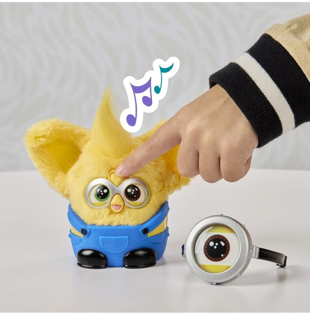 Furby Furblets Minions plush toy with head button being pressed for sounds