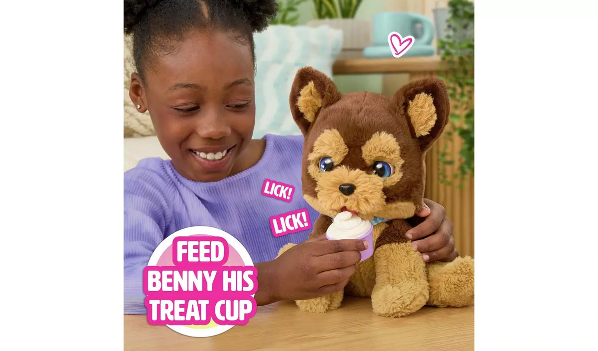 Child feeding FurReal Benny the Kiss and Cuddle Pup with treat cup
